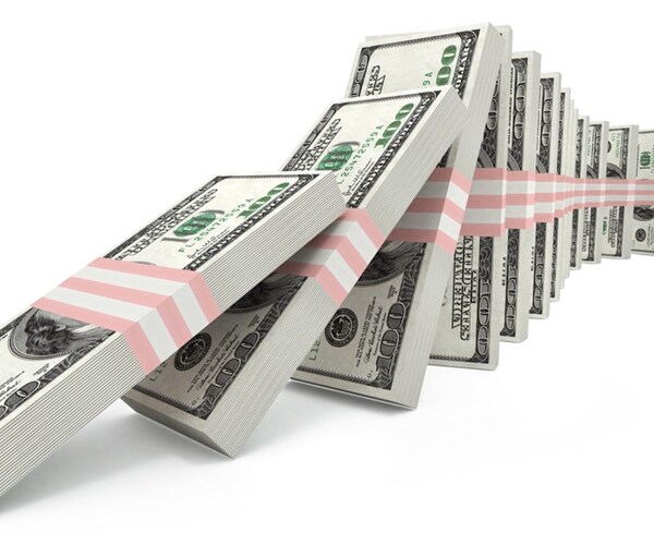 packs of us dollars falling down like domino.