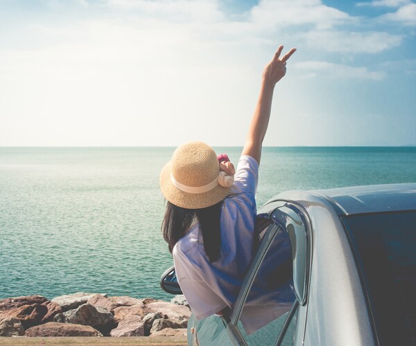 a woman excited to be at the beach