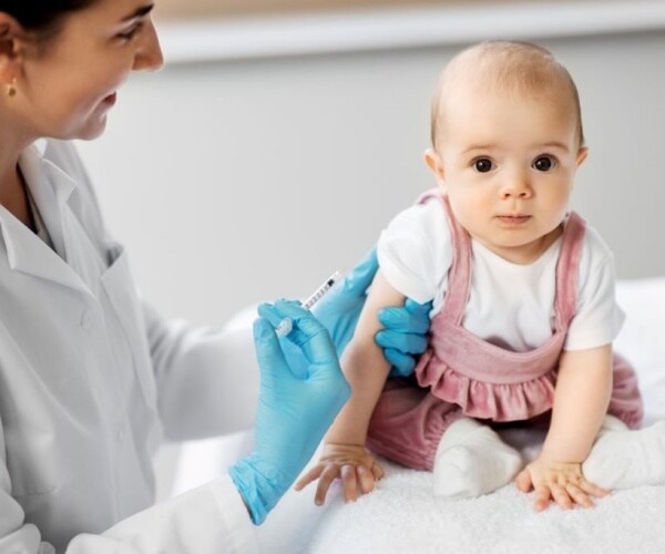doctor giving baby a vaccine