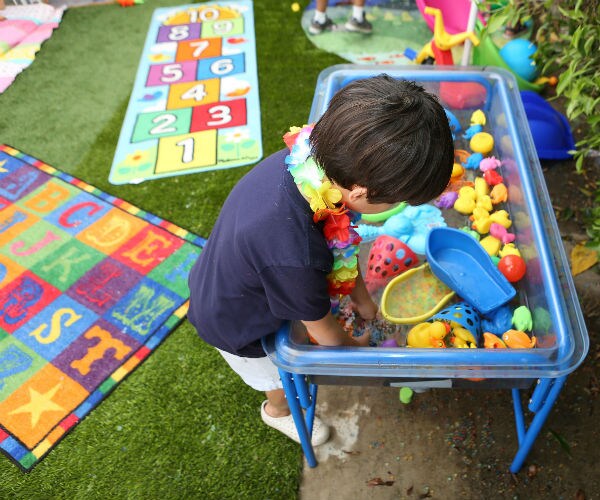a child is shown playing with colorful toys a summer camp 