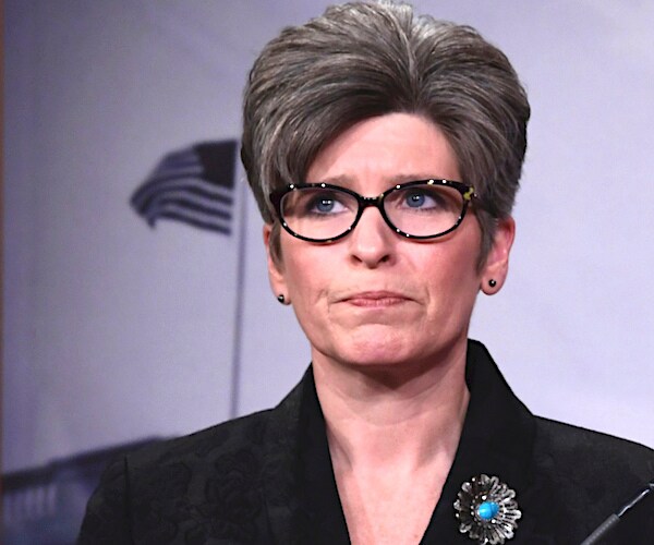 joni ernst looks on during a media appearance