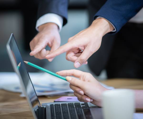 hands pointing at a computer screen