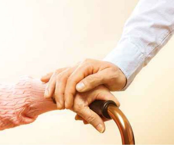 senior person's hand with doctor giving comfort