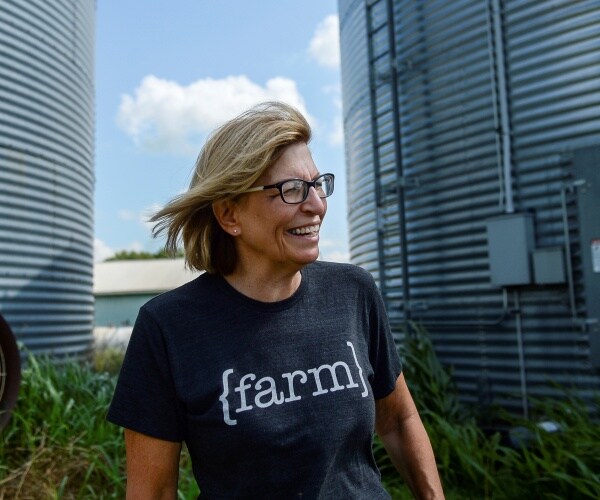 hart in a t shirt with "{farm}" on it standing outside