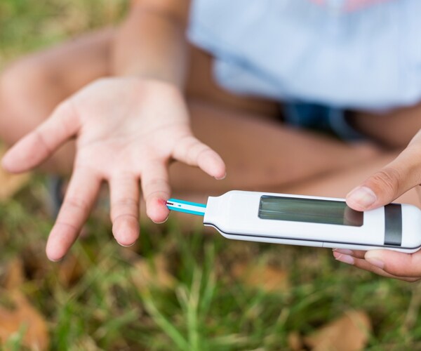 a young girl testing her blood