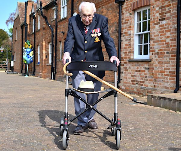 British World War II veteran Captain Tom Moore poses with his walking frame doing a lap of his garden