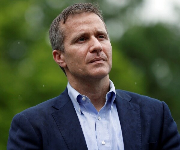 eric greitens stands outside