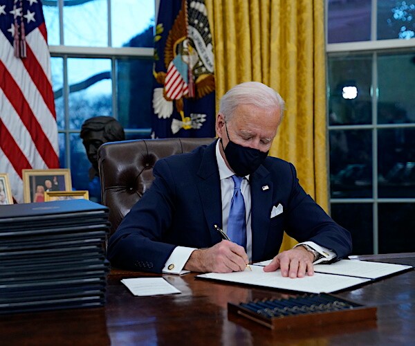 joe biden signs a number of executive orders on his first day in the oval office