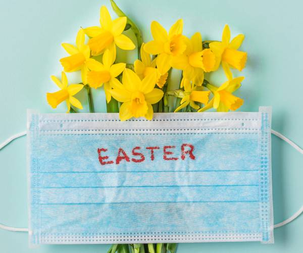 daffodils behind a surgical mask with easter written on it