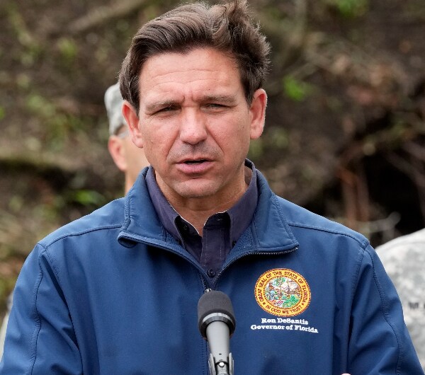 Ron DeSantis speaks into a microphone