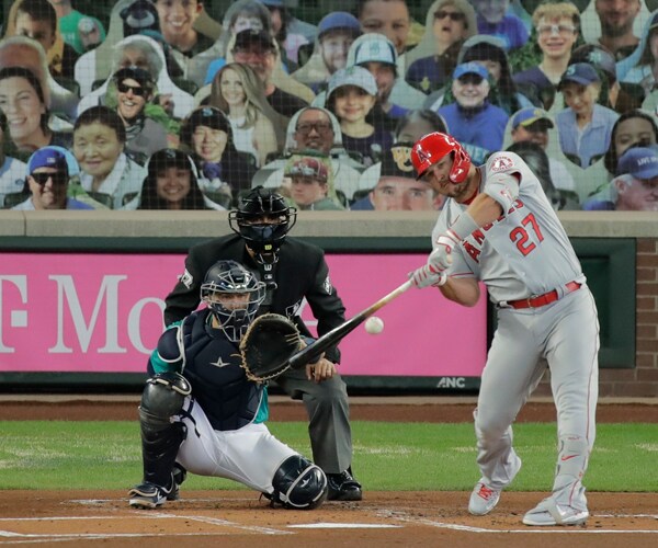 mike trout of the los angeles angels swings at a pitch against the seattle mariners