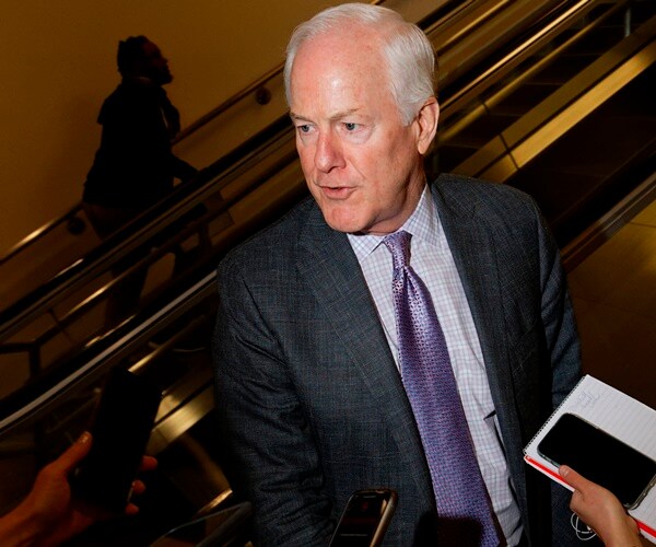 john cornyn speaks with reporters from the escalator in the capitol
