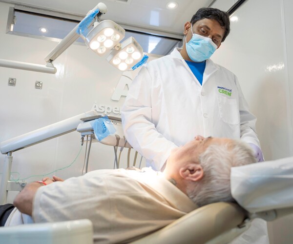 a dentist in fayetteville north carolina confers with a patient