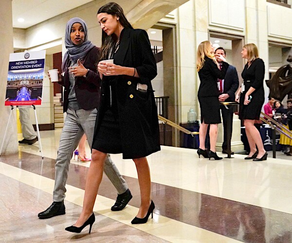 ilhan omar and alexandria ocasio-cortez walk through the halls of capitol hill