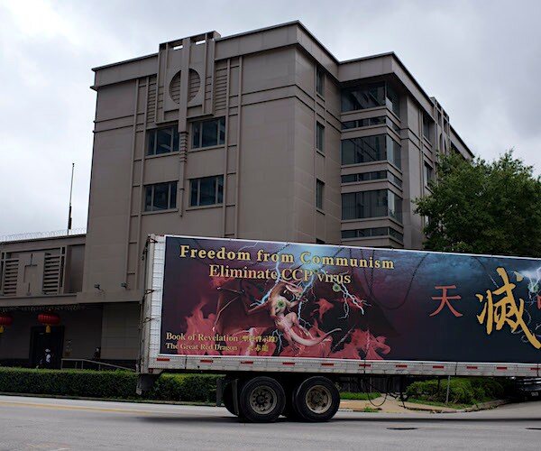 A truck drives past the Chinese consulate in Houston after the U.S. State Department ordered it closed