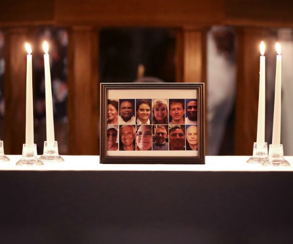 a photograph of the victims with candles on the sides
