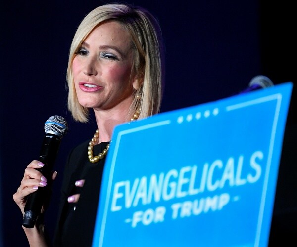 paula white cain speaks into microphone