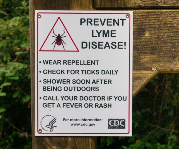 a sign warning people to protect themselves from lyme disease