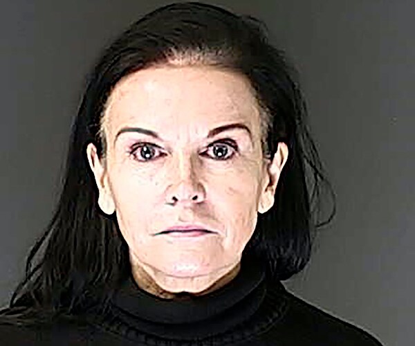 a sheriff's office mugshot of a dark-haired, pale-skinned woman named carla faith