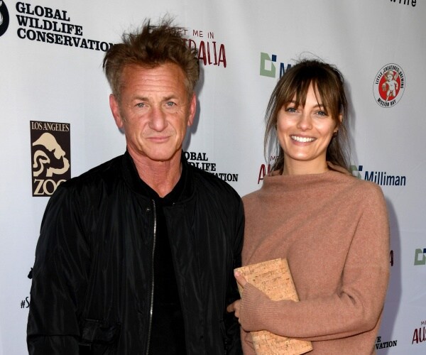 sean penn in a black jacket and leila george in a tan colored sweater