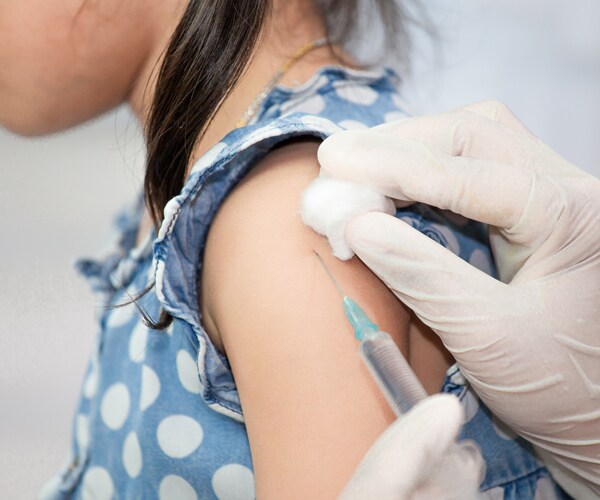 a young girl receiving a vaccine