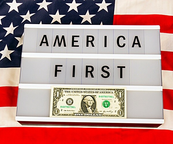 lightbox with letters - america first - on an american national flag 

