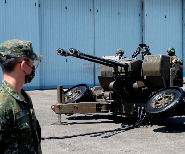 taiwanese soldiers operate a cannon anti-aircraft gun