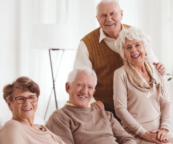 two smiling, happy older couples