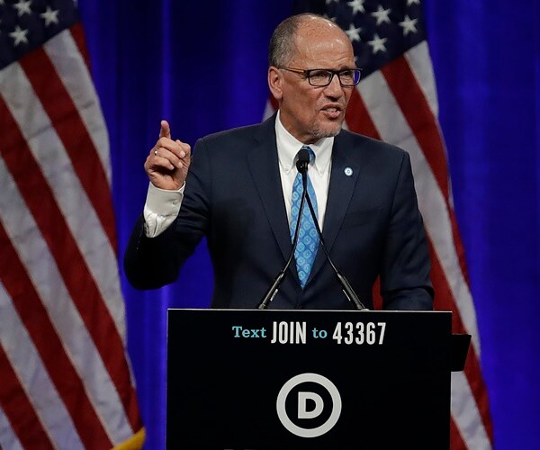 tom perez speaks on a stage and gestures.