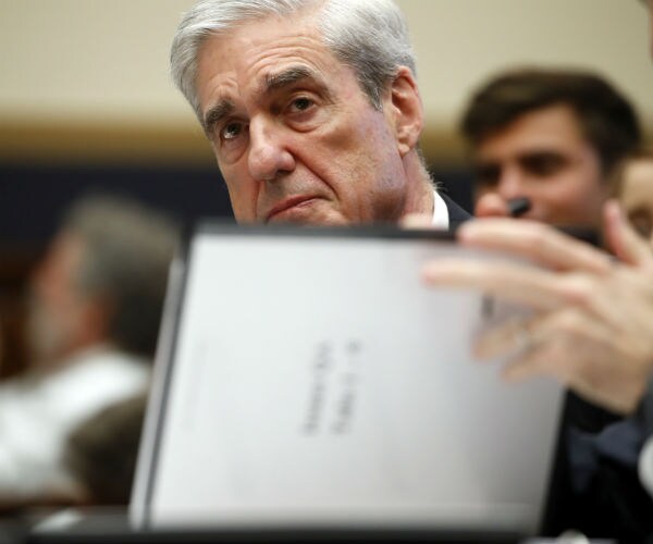 former special counsel robert mueller, checkks pages in the report as he testifies before the house judiciary committee