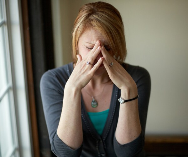 a woman holding her head