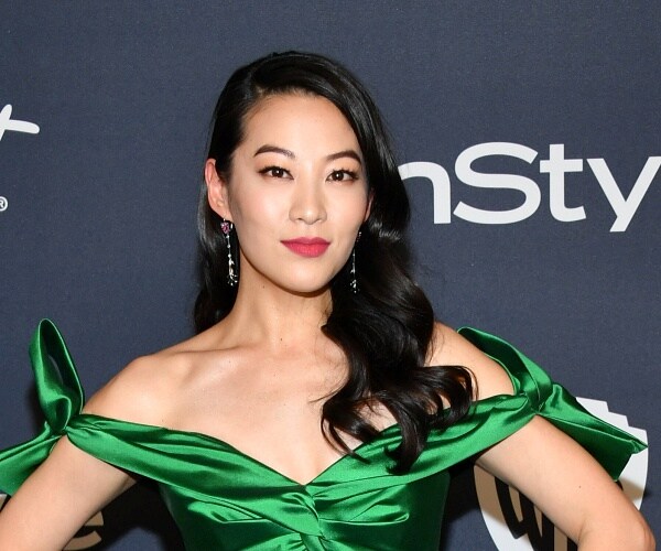 arden cho stands on red carpet