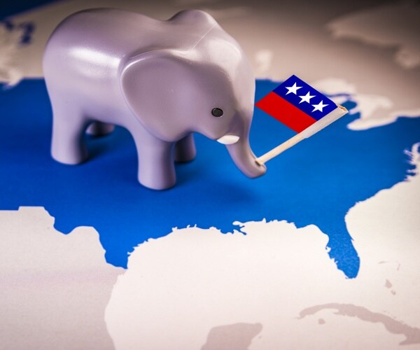 toy elephant holding a republican party flag over a usa map