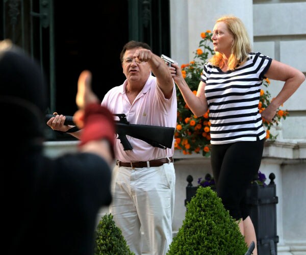 mark in pink polo shirt and patricia mccloskey in black and white striped top and black pants 