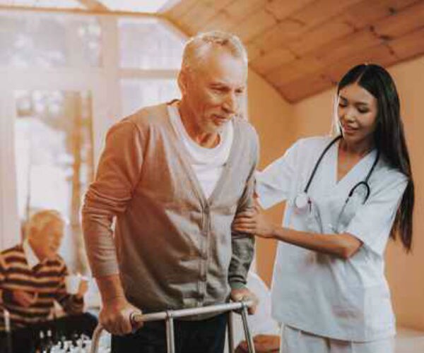 a nurse is shown helping an elderly man using a walker