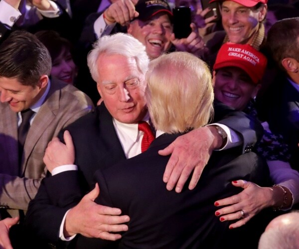 trump hugging his brother robert surrounded by a crowd of supporters