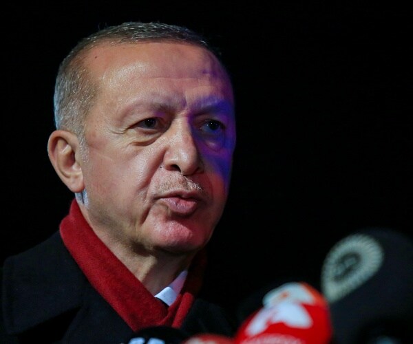 tayyip erdogan speaks into microphone