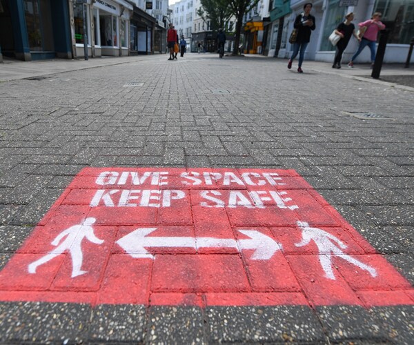 social distancing guidance on a sidewalk