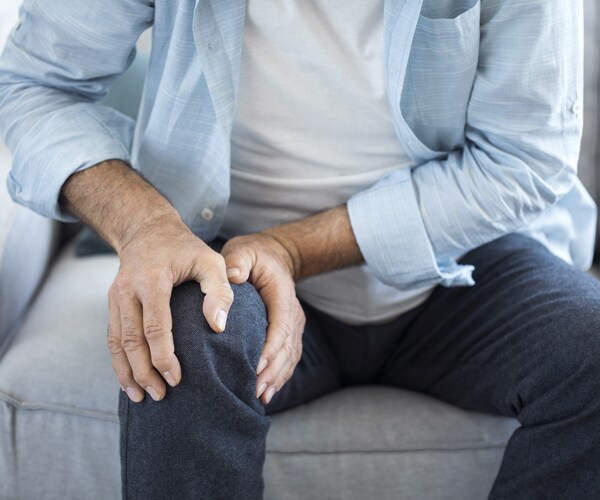 a man suffering from knee pain