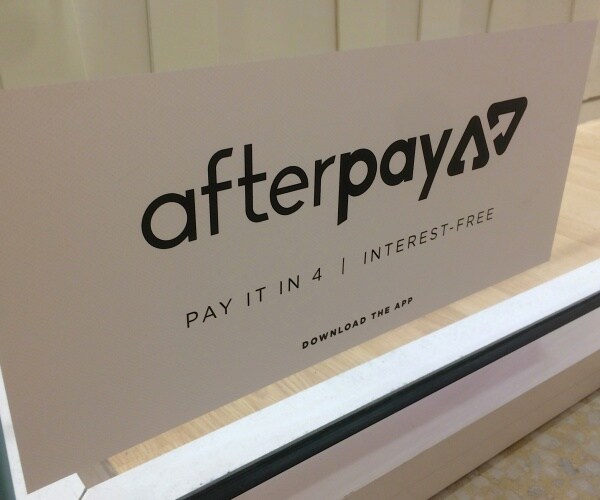 Afterpay App sticker placed on a shopfront window.