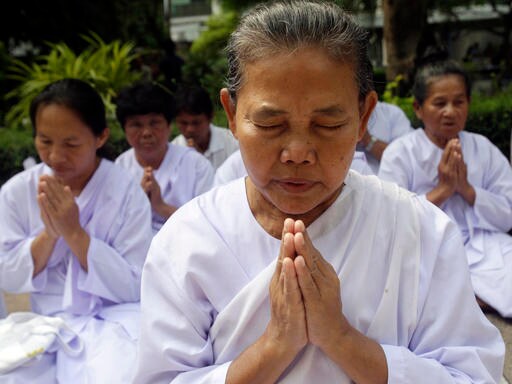 Thais Waiting for Word on King's Health Pray, Offer Flowers