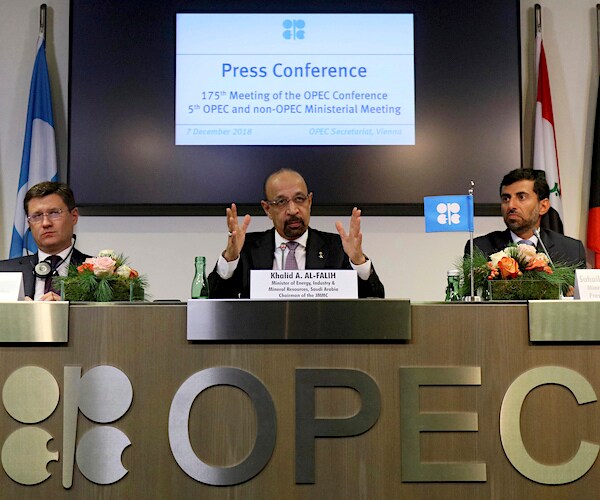 people sit on a dais that reads Oh pee e sea