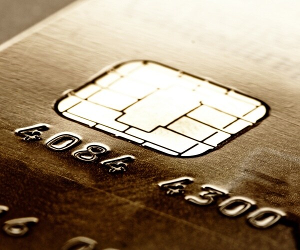 A macro detail of a golden credit card 
