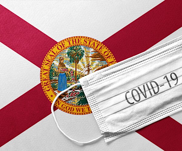 the florida flag with a face mask marked covid-19