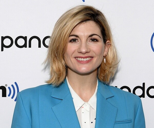 jodie whitaker stands on red carpet