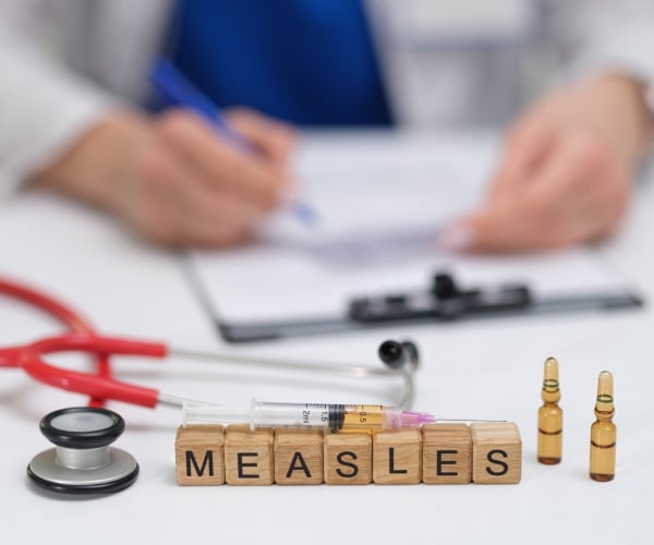 doctor with measles sign, papers, stethoscope