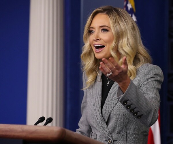 kayleigh mcenany in a gray coat and black top speaking in the press briefing room