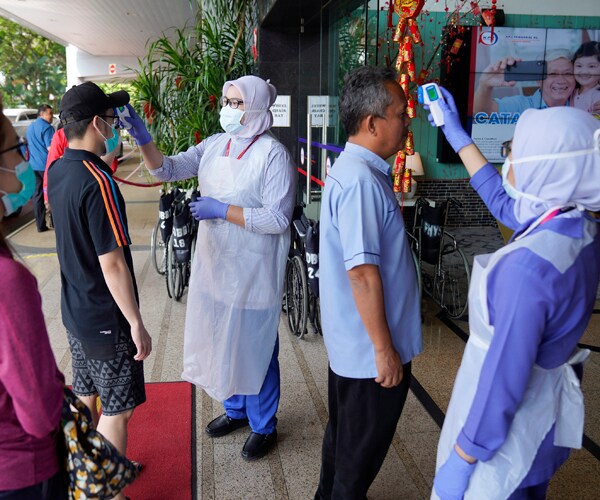 nurses check people's temperatures at a hospital in kuala lumpur, malaysia