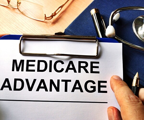 medicare advantage in a clipboard. health care insurance concept