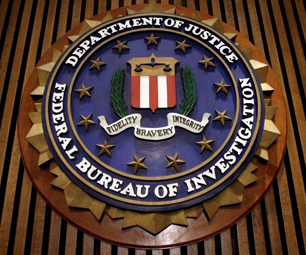 fbi seal is shown with wood slats behind it